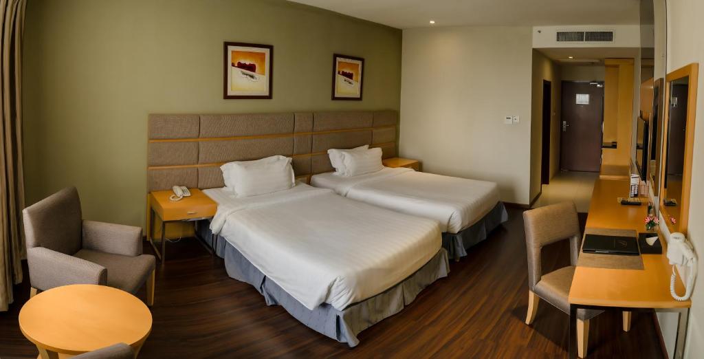 En eller flere senge i et værelse på Seri Simanggang Hotel