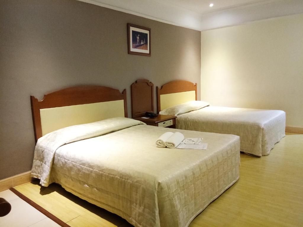 Postel nebo postele na pokoji v ubytování Purnama Hotel