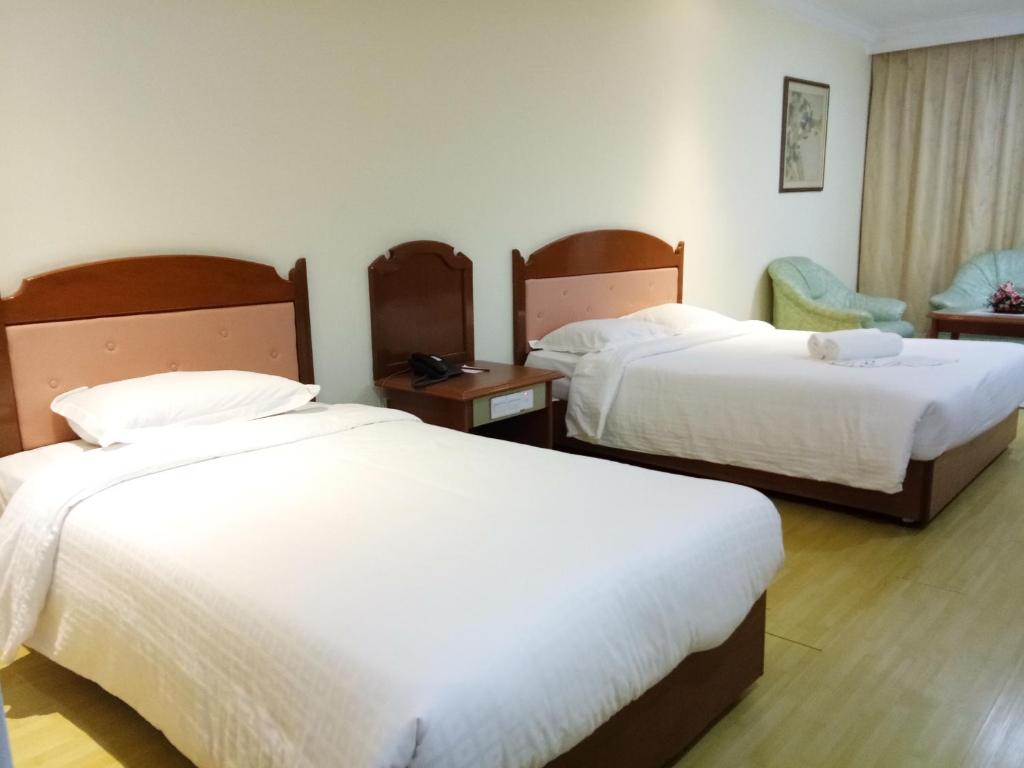 Postel nebo postele na pokoji v ubytování Purnama Hotel