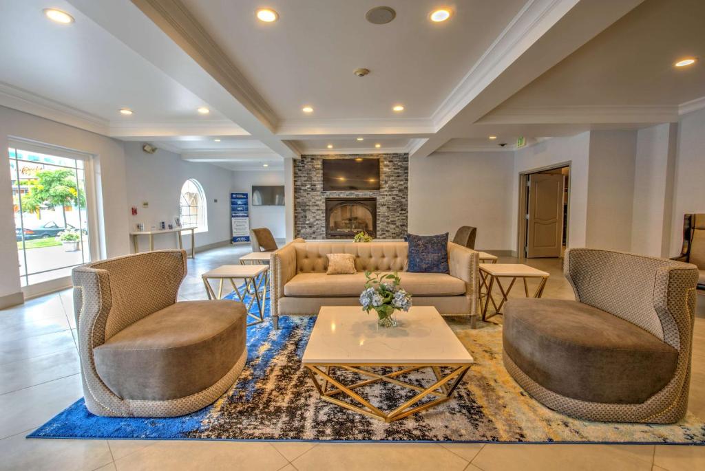 a living room with a couch and chairs and a table at Best Western Plus Media Center Inn & Suites in Burbank