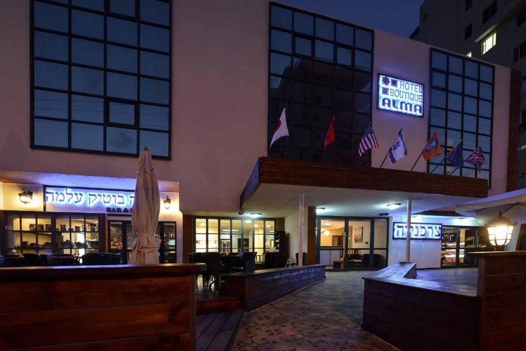 a lobby of a hotel with a bar and a restaurant at Hotel Alma - Near The Sea in Netanya