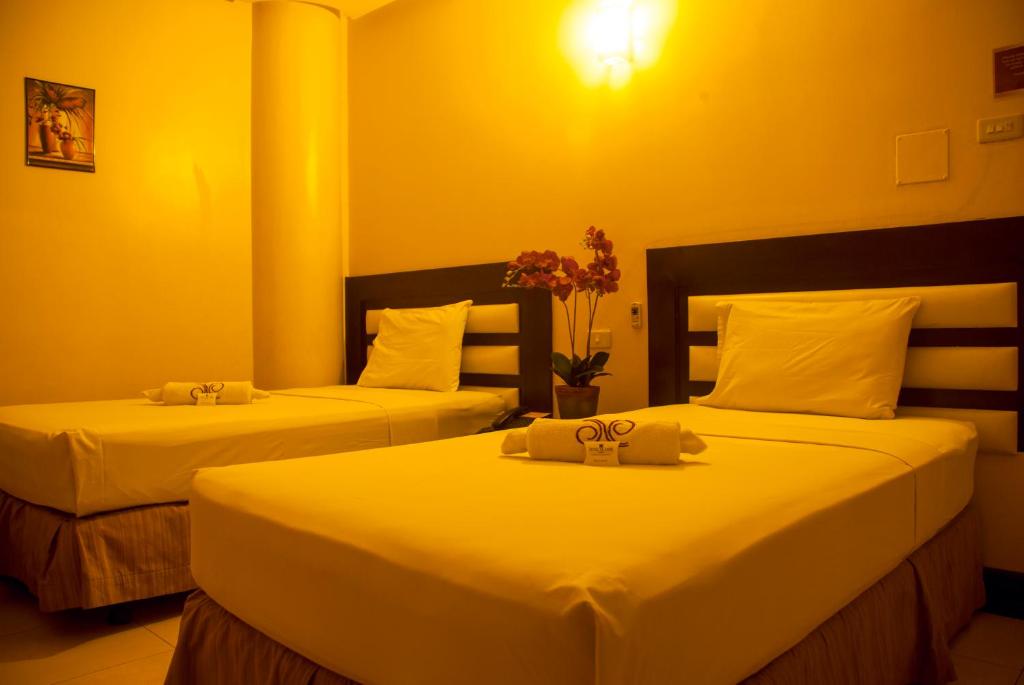 Una cama o camas en una habitación de Hotel Nicanor
