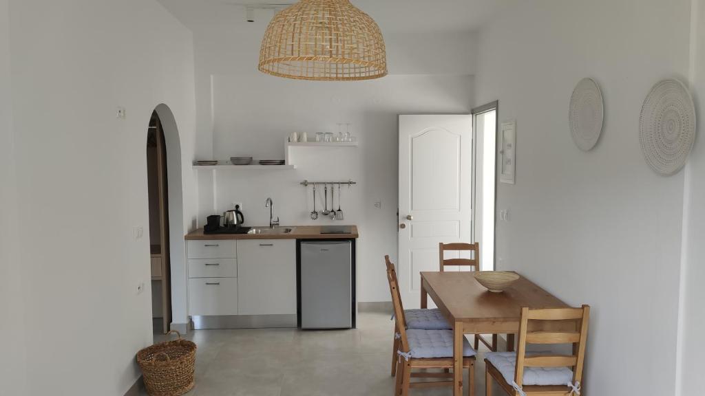 a kitchen with a table and chairs and a dining room at Ellie Apartments Stalida in Stalida