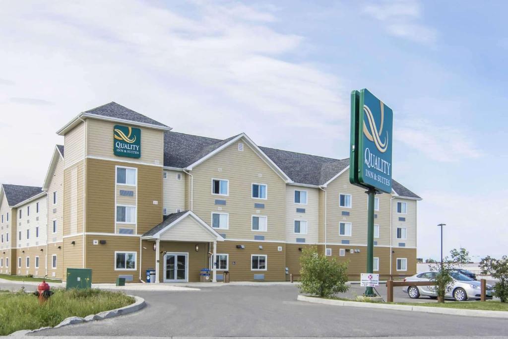 a large building with a sign in front of it at Quality Inn & Suites Thompson in Thompson