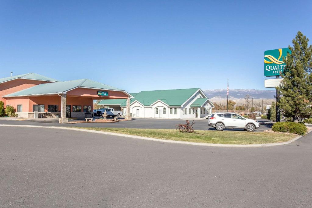 a car is parked in front of a gas station at Quality Inn Delta Gateway to Rocky Mountains in Delta