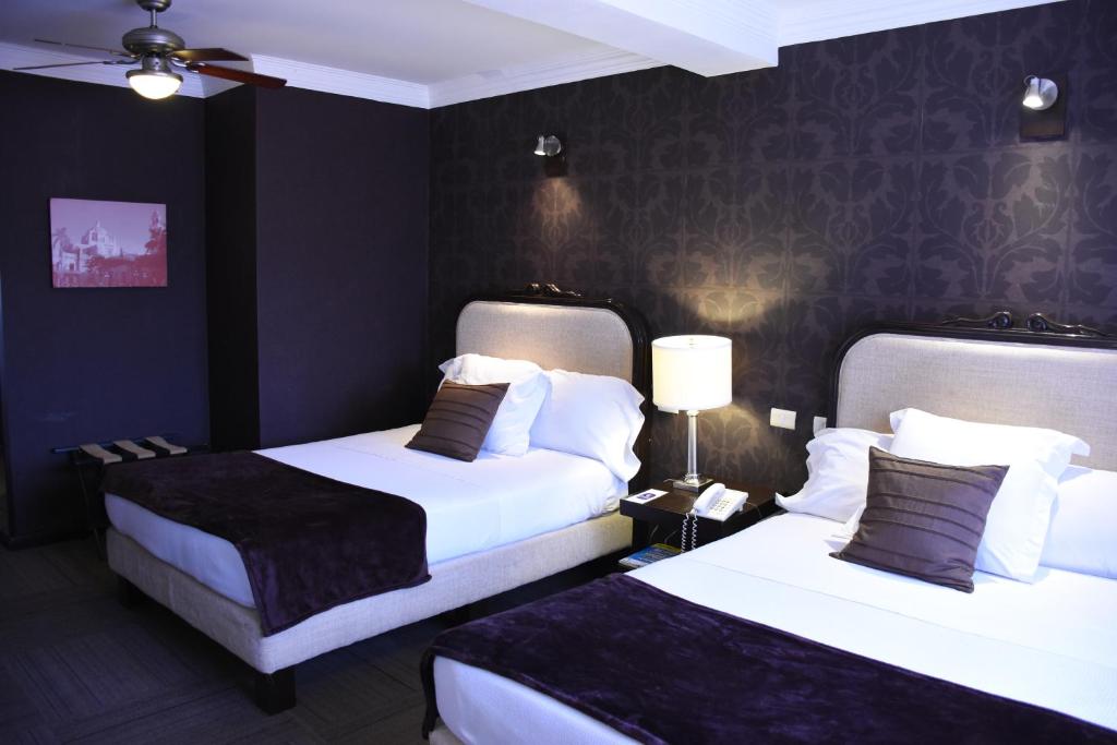 Postel nebo postele na pokoji v ubytování Hotel Clara Luna