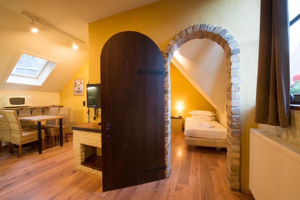 a room with an arched door and a bedroom at City Flats by Lybeer Hotel Group in Bruges