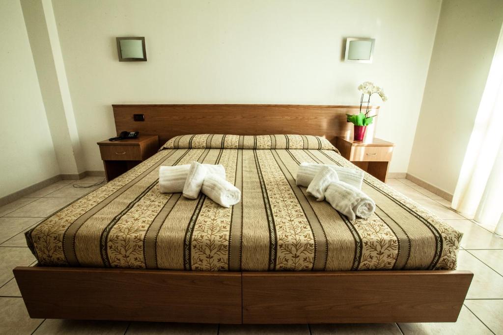 a bedroom with a bed with towels on it at Hotel Davide in Rivoli