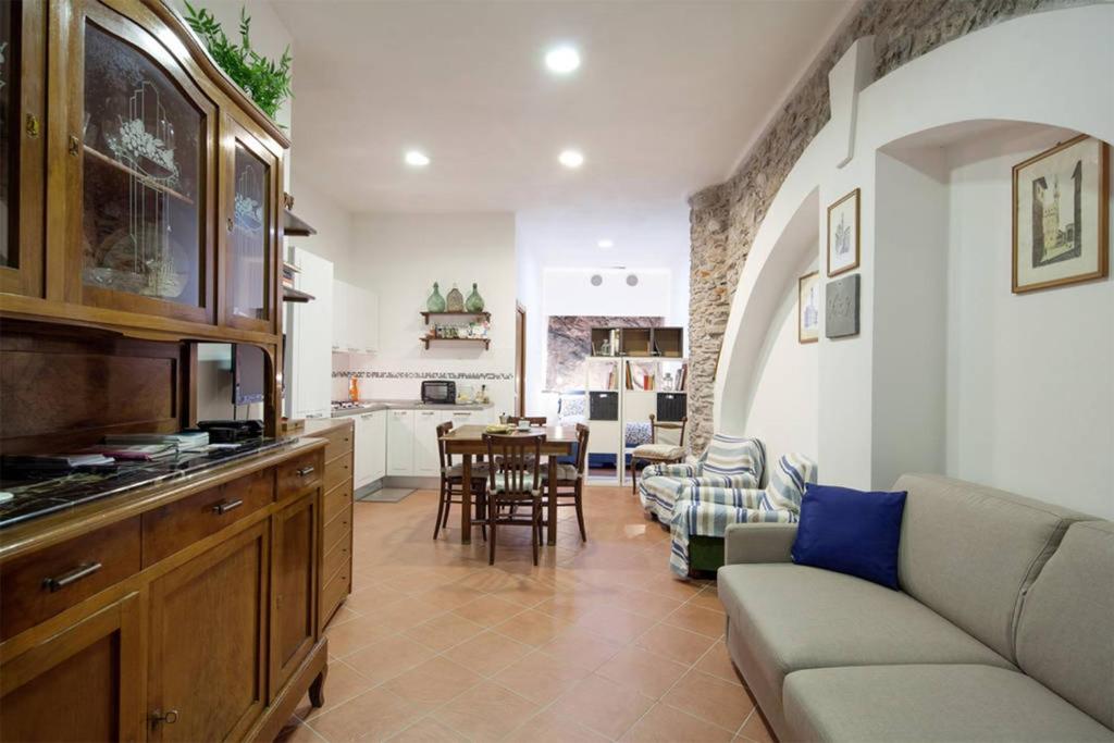 a kitchen and a living room with a couch and a table at La Cantina di Lorenza in Vernazza