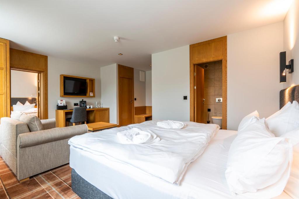 Ένα ή περισσότερα κρεβάτια σε δωμάτιο στο HVD Grand Hotel Suhl Business & Leisure