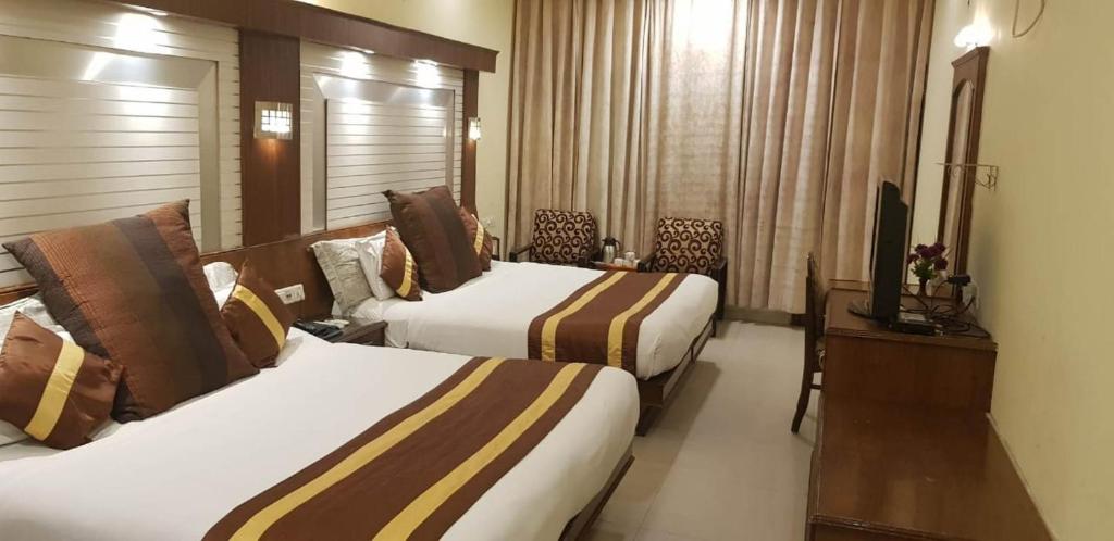 Postel nebo postele na pokoji v ubytování Hotel CJ International
