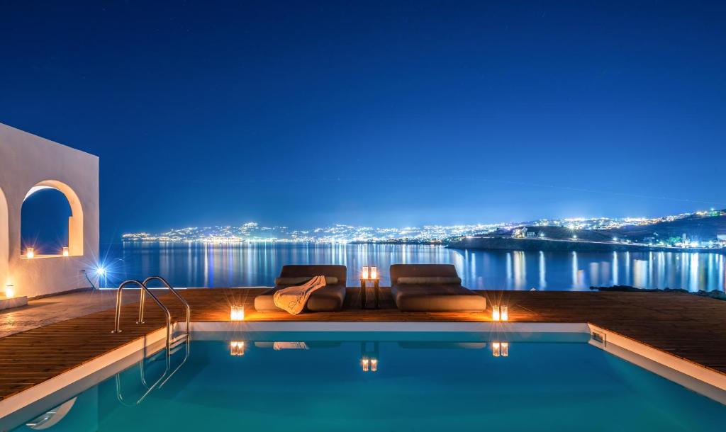 una piscina con vistas a la ciudad por la noche en Dreambox Mini Villas en Ornos