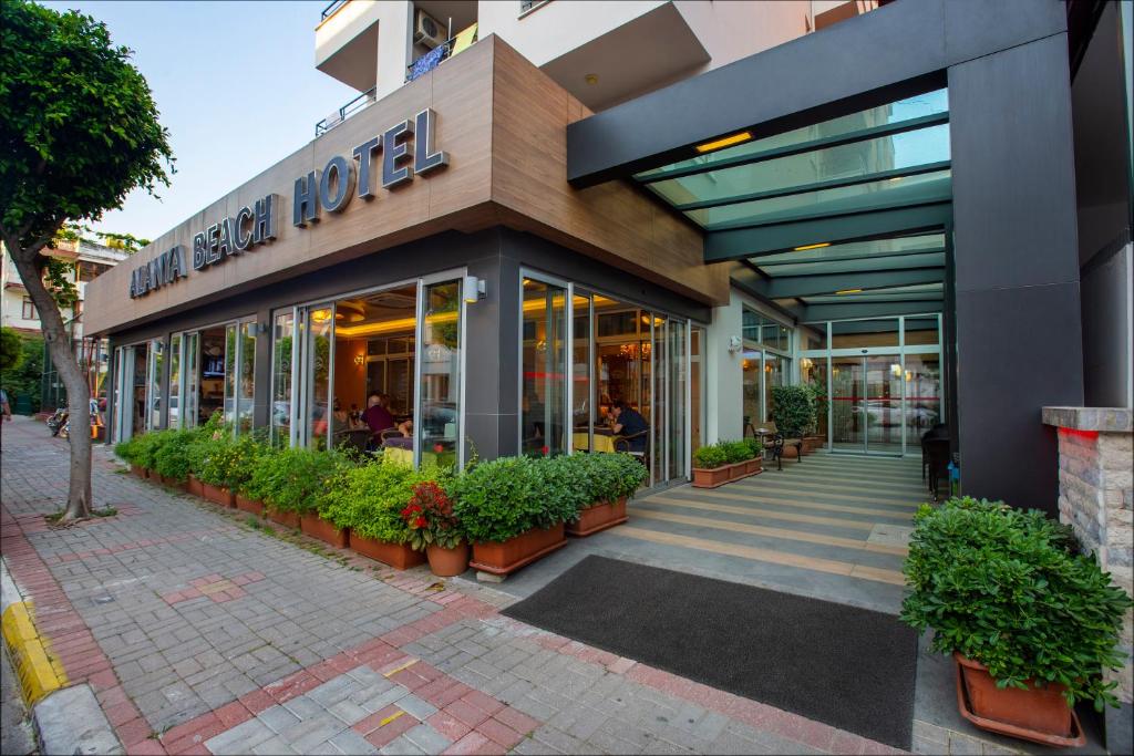 a store front of a building with potted plants at Alanya Beach Hotel in Alanya