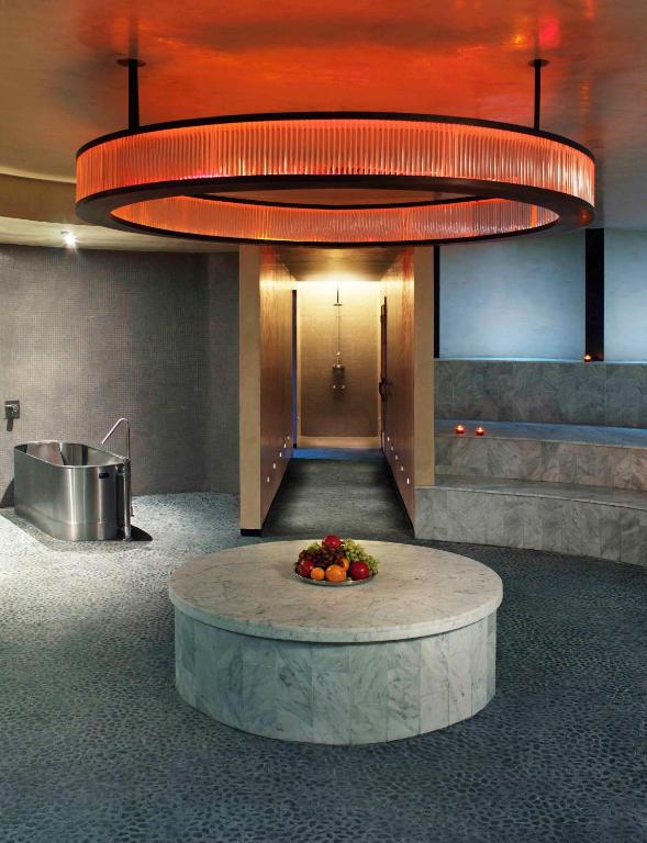 a lobby with a bowl of fruit and a large light fixture at The Standard Miami in Miami Beach