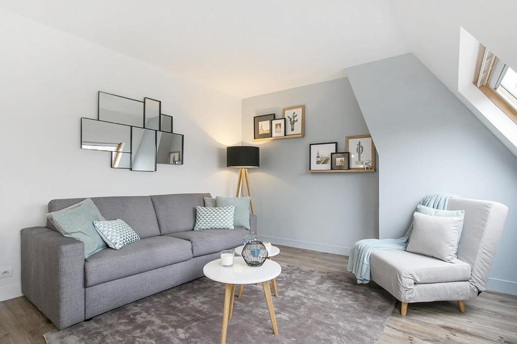 a living room with a couch and a chair at Dreamyflat - Champs Elysées in Paris