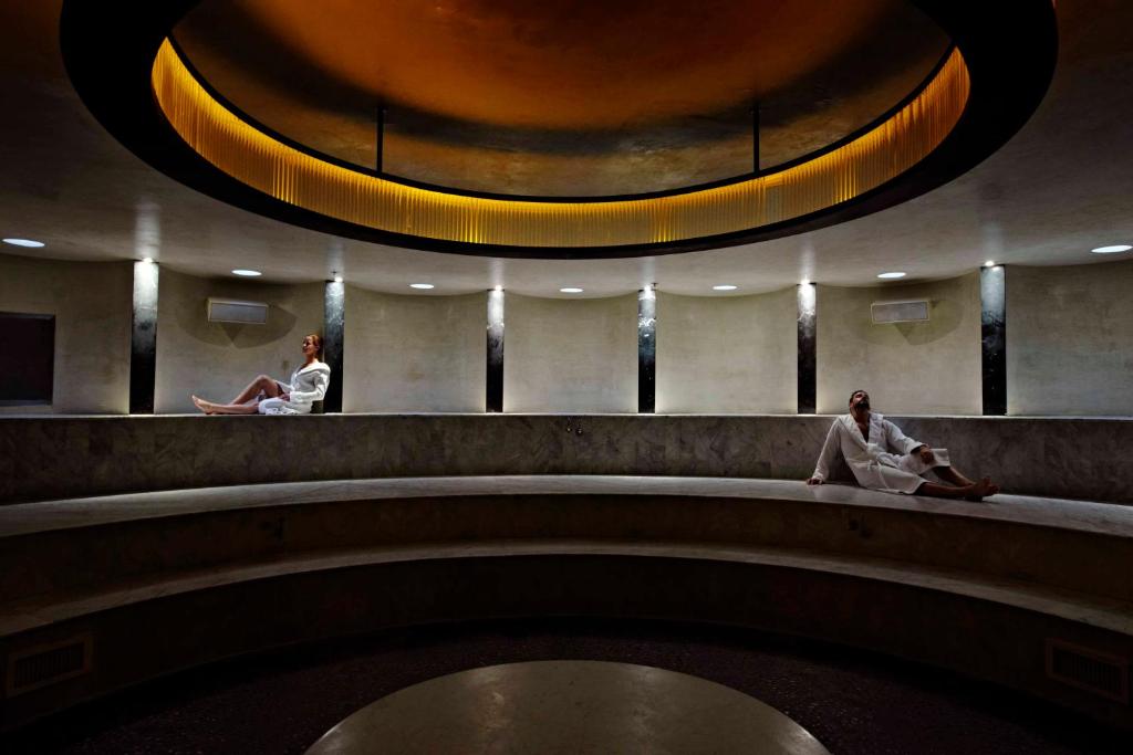 two women sitting on a bench in a building at The Standard Miami in Miami Beach