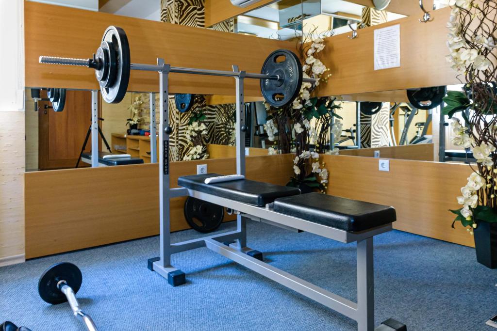 a gym with a bench and a barbell at Sweet Homes Apartments in Sunny Beach