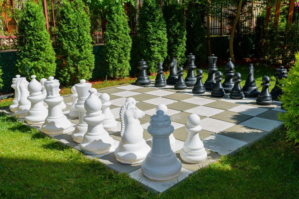 a giant chess board on the grass in a yard at Sweet Homes Apartments in Sunny Beach