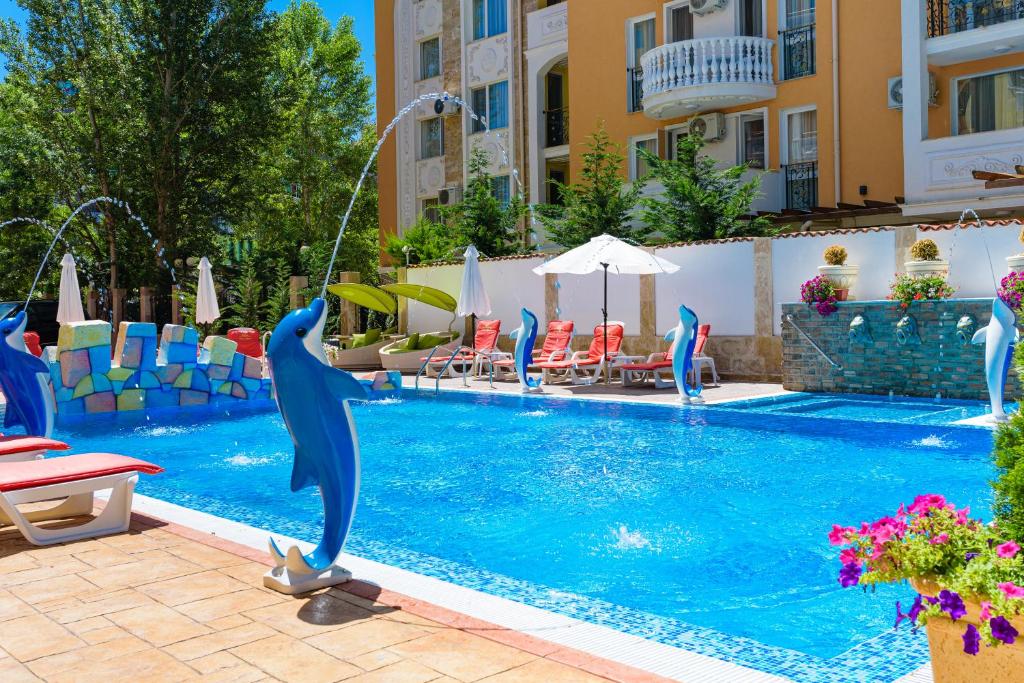 a pool with a dolphin in the middle of it at Sweet Homes Apartments in Sunny Beach