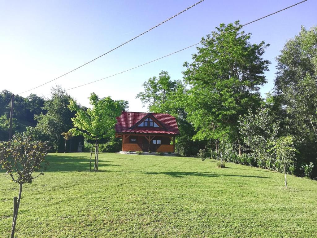 a house in the middle of a grassy field at Brunarica Lorentia in Bizeljsko