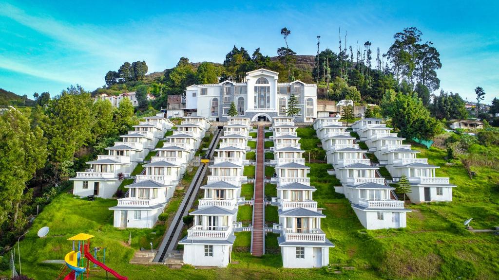 a row of white houses on a hill at La Montana by TGI in Ooty