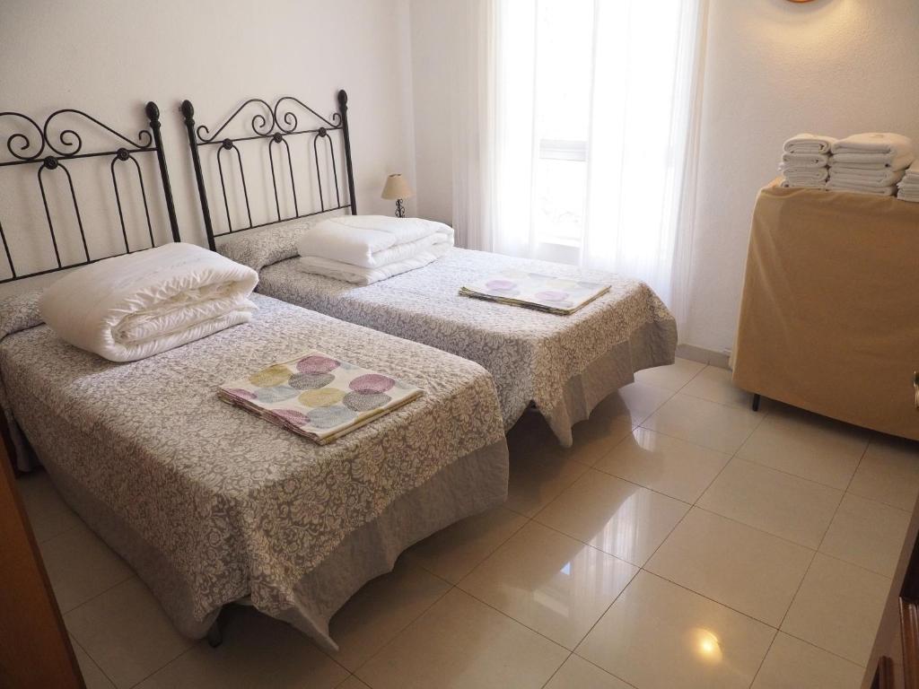 Postel nebo postele na pokoji v ubytování Apartamentos Intercentro Algarrobo-Costa APARTAMENTOS TURÍSTICOS -INMOBILIARIA