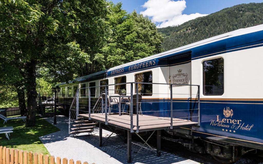 a blue and white train with a platform on it at Luxury Lodge - Orient Express Lener in Campo di Trens