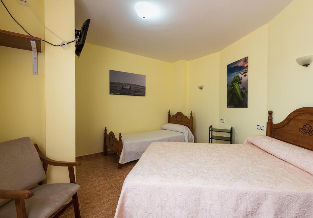 Posteľ alebo postele v izbe v ubytovaní Hostal O Camouco
