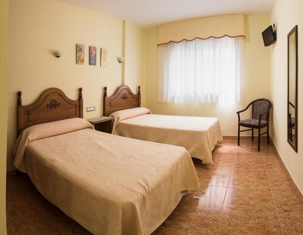 Posteľ alebo postele v izbe v ubytovaní Hostal O Camouco