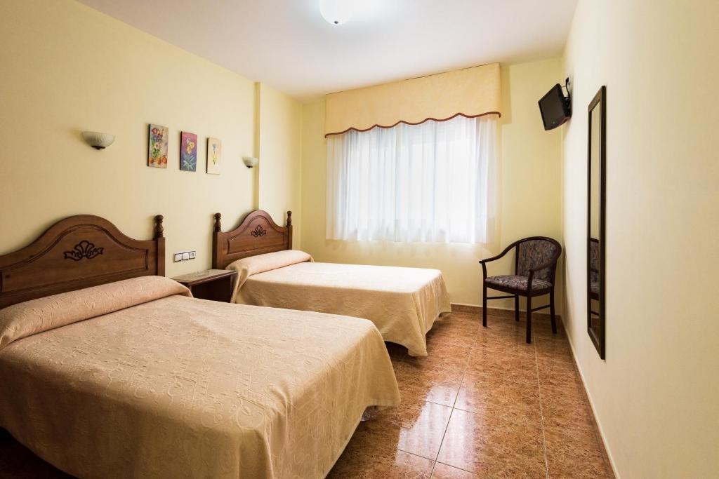 Posteľ alebo postele v izbe v ubytovaní Hostal O Camouco