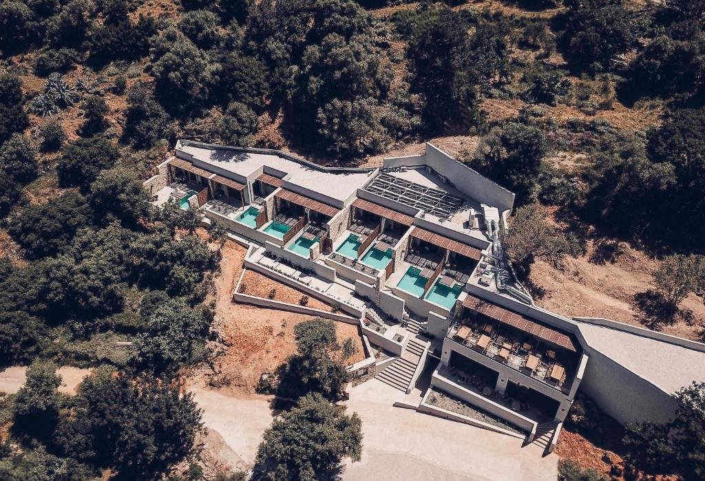 an aerial view of a large building with a train at Monastery Estate Retreat in Sougia