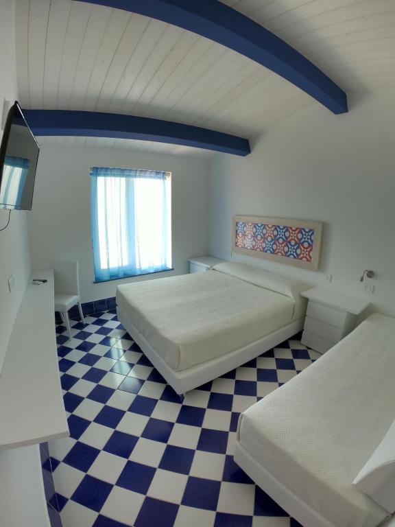 Postel nebo postele na pokoji v ubytování Hotel La Nave