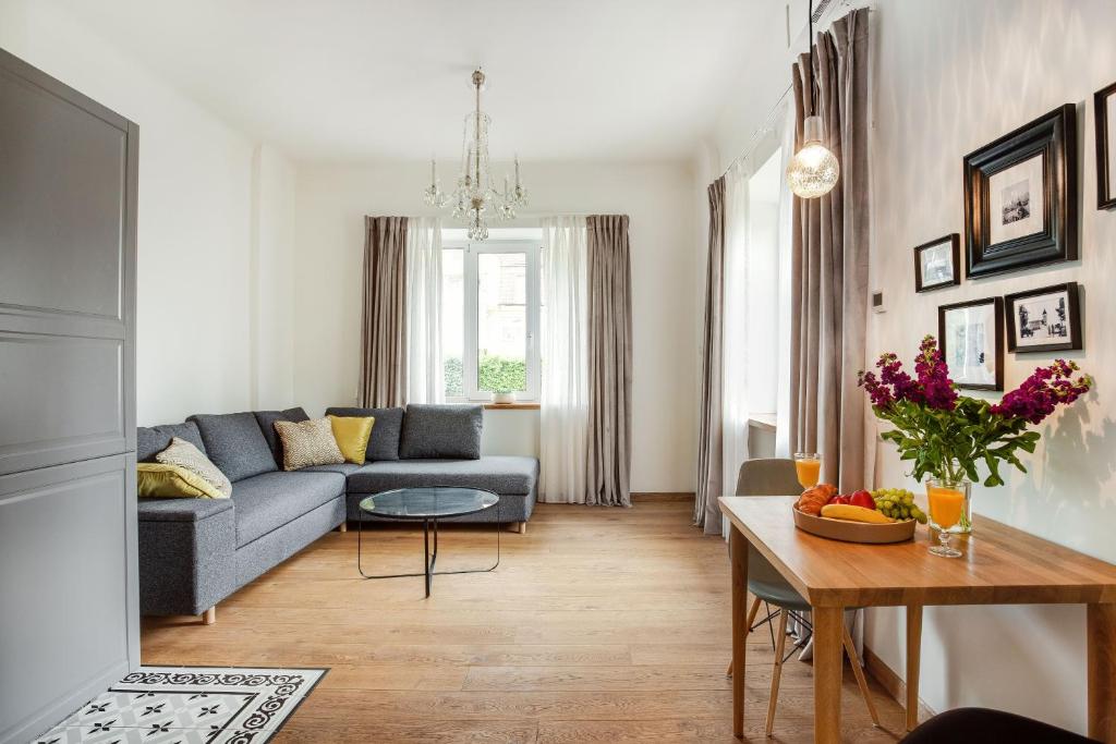 a living room with a couch and a table at Bright and Cosy 1BDR apartment Kaunas Centre in Kaunas