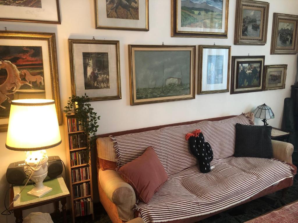 a living room with a couch and pictures on the wall at Casa Violante in Verona