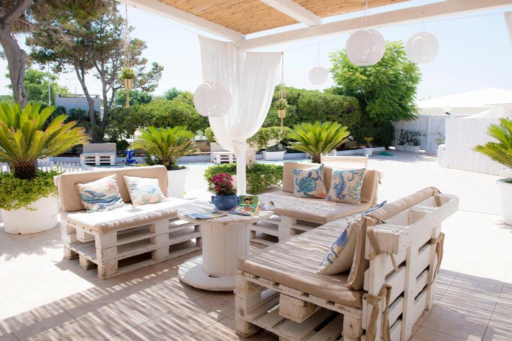 a patio with couches and a table and chairs at Hotel San Giovanni in Polignano a Mare