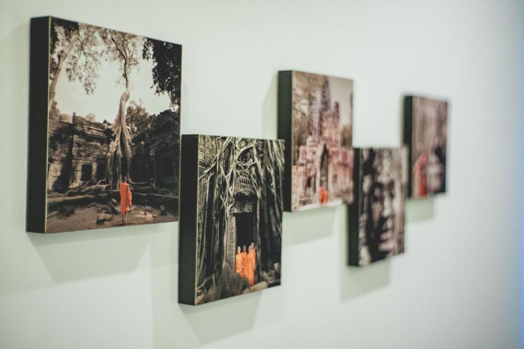 a group of pictures hanging on a wall at My Resort Beach Apartment in Hua Hin