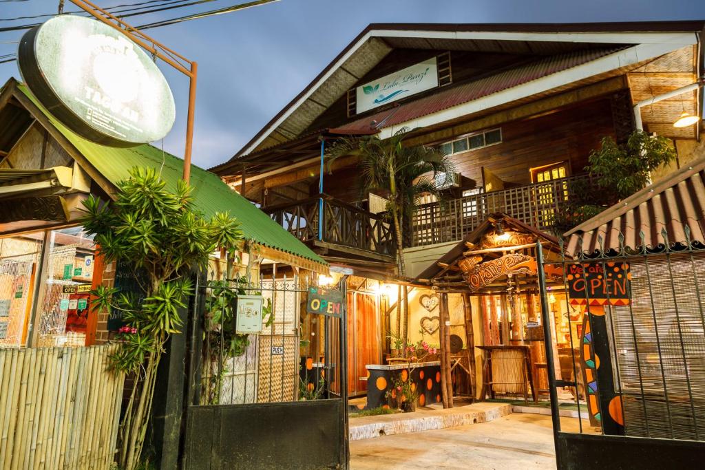 a house with a balcony on top of it at Lala Panzi Bed and Breakfast in Puerto Princesa City
