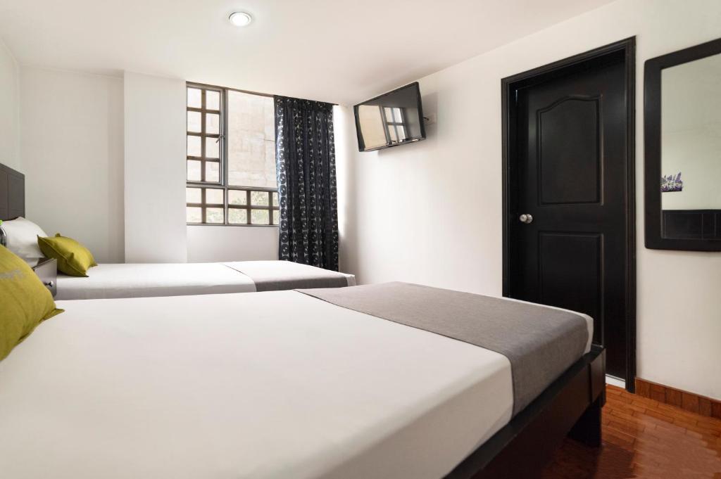 Postel nebo postele na pokoji v ubytování Hotel Dorado 100