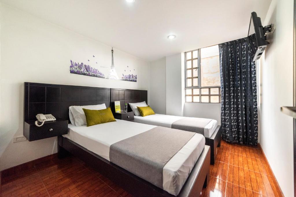 Postel nebo postele na pokoji v ubytování Hotel Dorado 100