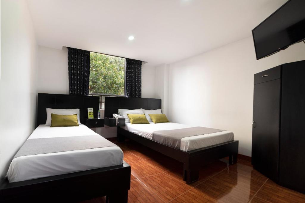Postel nebo postele na pokoji v ubytování Hotel Dorado 100