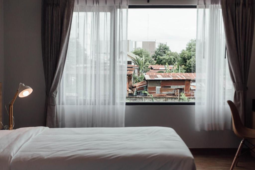 Postel nebo postele na pokoji v ubytování Clay Hotel Udonthani