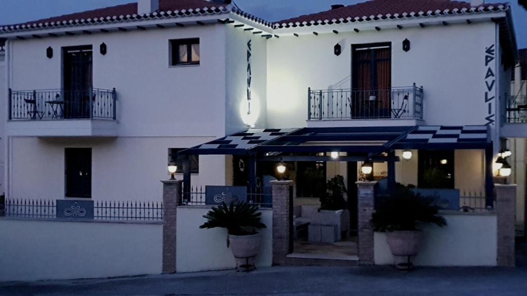 a large white building with plants in front of it at ''EPAVLIS boutique GALAXIDI'' in Galaxidi