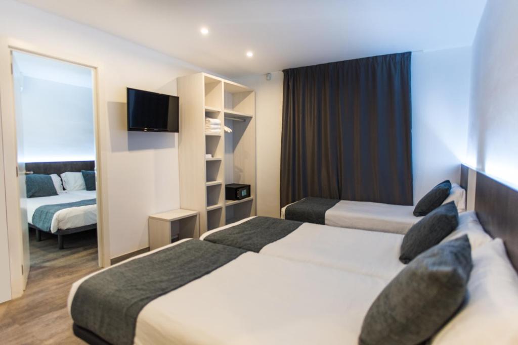 Postel nebo postele na pokoji v ubytování Hostal Ribas