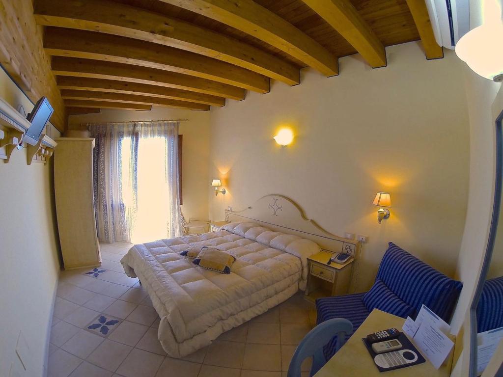 Postel nebo postele na pokoji v ubytování Hotel La Nave
