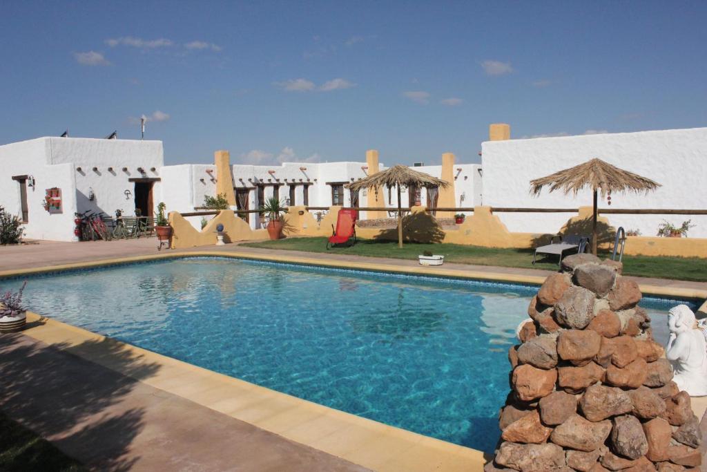 a large swimming pool in front of a building at Olivares Rural in Los Albaricoques