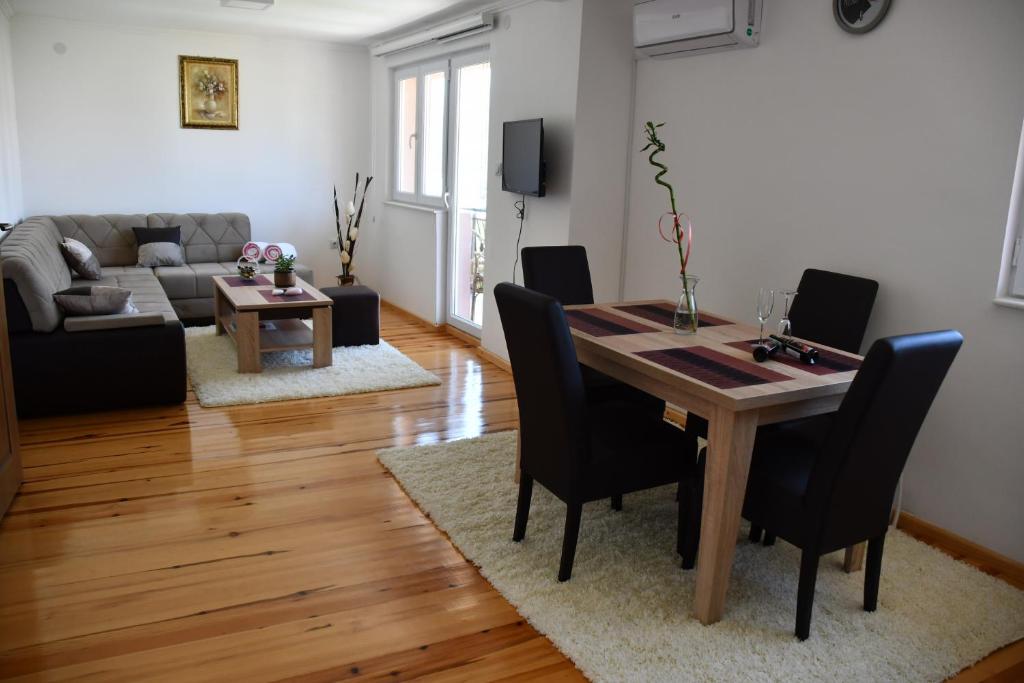 un salon avec une table et des chaises en bois dans l'établissement Apartman Vesna, à Višegrad