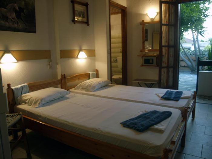 sypialnia z dużym łóżkiem z dwoma ręcznikami w obiekcie Mitsa w mieście Skiatos