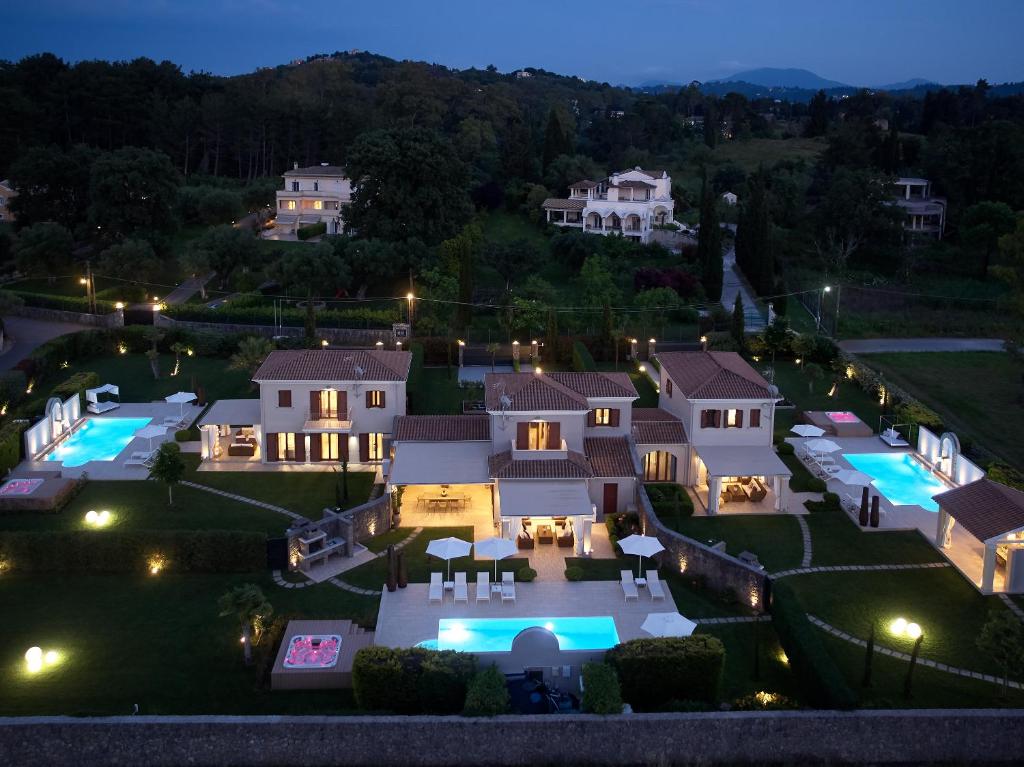 an aerial view of a mansion at night at S & O Villas Corfu in Dassia