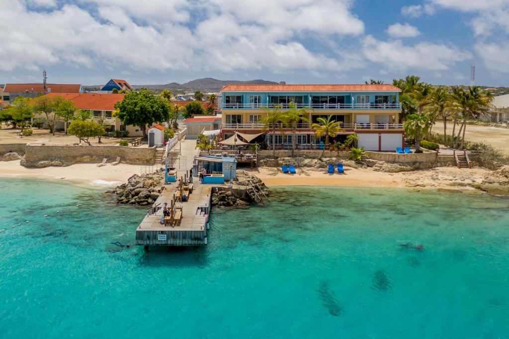 a dock in the water next to a resort at Oceanfront Apartment Yellow Tail Snapper at Den Laman in Kralendijk