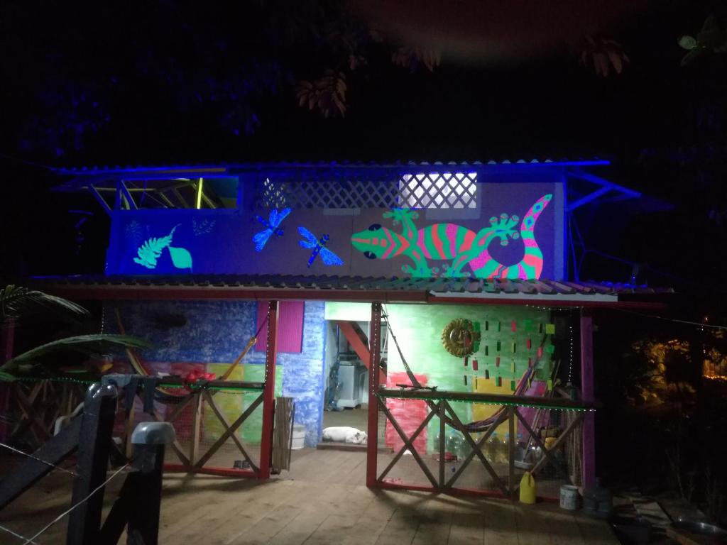 a house with a wall with colorful graffiti on it at La Salamandra in Ladrilleros